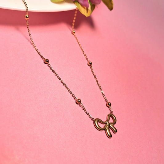 Stainless steel necklace with gold bow tie design